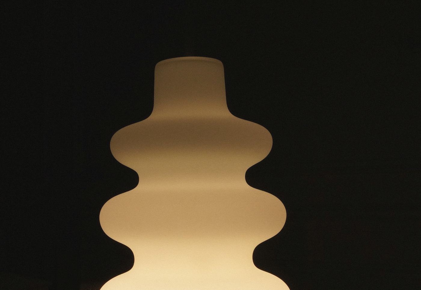 The diffuser glowing warm amber in a dark room at night